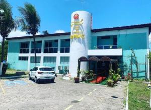 a white car parked in front of a building at Hotel de Trânsito da PM-PE in Olinda