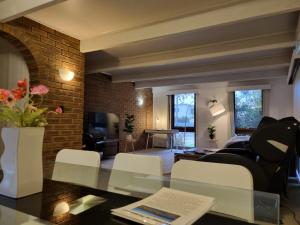 a living room with a glass table and white chairs at Warm Cosy Paynesville Get-Away in Paynesville