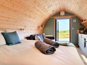 a room with a large bed with towels on it at Wheal Breage - Uk41265 in Germoe