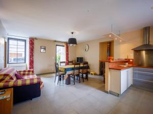 a kitchen and living room with a table and chairs at Maison Loudenvielle, 3 pièces, 6 personnes - FR-1-695-28 in Loudenvielle