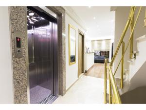 a hallway with a metal door in a building at Zendy Suite Hotel in Istanbul