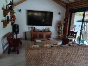 a living room with a flat screen tv on the wall at Fincas Panaca Herreria 1 - San Judas in Quimbaya