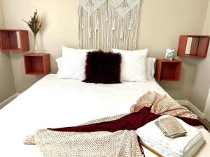 sypialnia z białym łóżkiem z czarną poduszką w obiekcie Cozy Bohemian Home w/ Hot Tub in Mesa w mieście Mesa