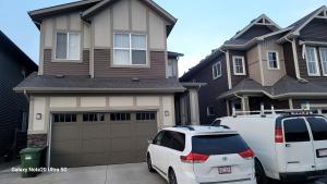 a white van parked in front of a house at A very nice Basement ensuite. in Calgary