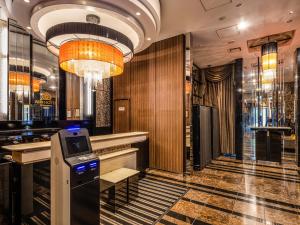 a lobby with a cash register in the middle of a bar at APA Hotel Ginza Shintomicho Ekimae in Tokyo