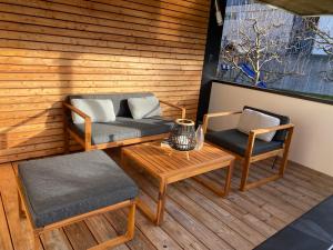 a patio with two chairs and a couch and a table at Appartement Two in Ötztal-Bahnhof