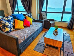 a living room with a couch and a table at Leisure Imperium Residence Studio Seaview Kuantan in Kuantan