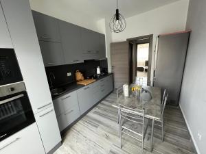 a kitchen with a table and chairs in a room at Casa di Afi, lago maggiore 5 min Perfect For 4 - Kitchen - Parking - Netflix in Arona