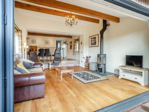 a living room with a couch and a fireplace at The Dairy in Skenfrith