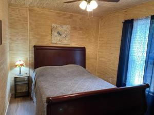 Schlafzimmer mit einem Bett und einem Deckenventilator in der Unterkunft The Fishing Dream in Swiss