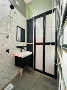 a bathroom with a sink and a shower at Hotel Casaria in Dungun