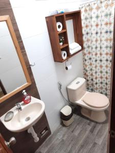 a small bathroom with a toilet and a sink at Casa Montero, acogedora y amplia. Iquitos-Peru in Iquitos