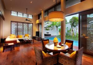 a living room with a table and chairs and a couch at InterContinental Bali Sanur Resort by IHG in Sanur