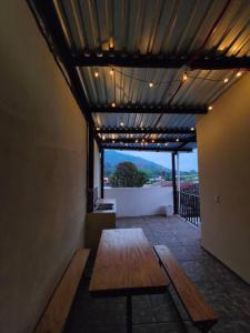 a room with a wooden table and a view at Casa completa en apaneca El salvador in Apaneca