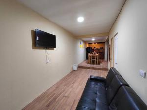 a living room with a couch and a flat screen tv at Casa completa en apaneca El salvador in Apaneca