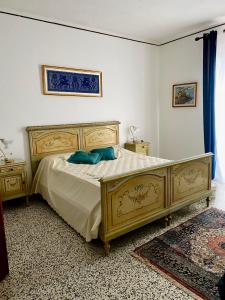 a bedroom with a bed with blue pillows on it at Pian Del Duca in Vesime