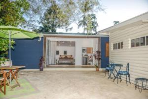 a patio with a table and chairs next to a building at Harmonic Haven in Witta