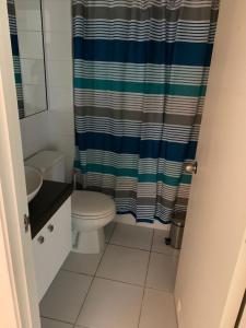 ein Bad mit einem WC und einem Duschvorhang in der Unterkunft departamentos La Serena in La Serena