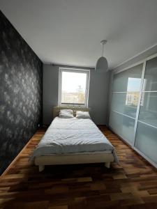 a bedroom with a bed and a window at Do Gdyni Exclusive in Gdynia