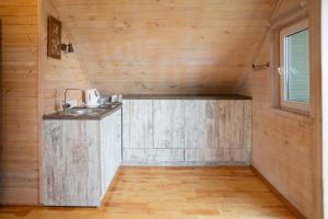 a kitchen in a tiny house with a sink at Rāznas Stāvkrasti in Kaunata +73 photos