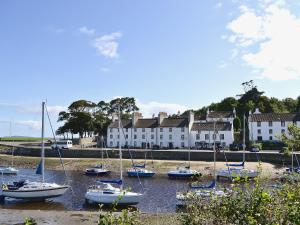 a group of boats are docked in the water at Cobble Cottage in Cramond