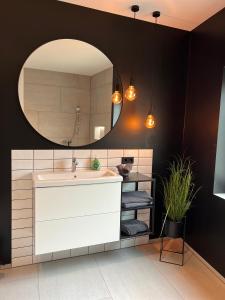 a bathroom with a sink and a mirror at Ferienhaus Rost in Volkach