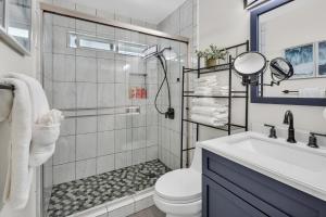 a bathroom with a shower and a toilet and a sink at Tower 9 #5 in Oceanside +49 photos