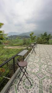 a row of tables and chairs on a tiled floor at Style Motorbikes Homestay Ha Giang in Ha Giang