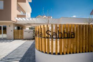 a sign on a fence in front of a building at B&B Vila Sabbia in Lopar