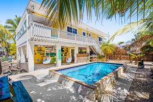 an exterior view of a house with a swimming pool at Key Lime Time in Cudjoe Key