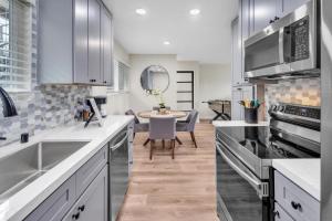 a kitchen with stainless steel appliances and a dining room at Tower 9 #4 in Oceanside