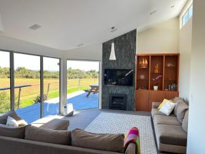 a living room with a couch and a fireplace at Harbour Lookout in Strahan