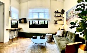 a living room with a couch and a table at De Pejoto in Tel Aviv +92 photos