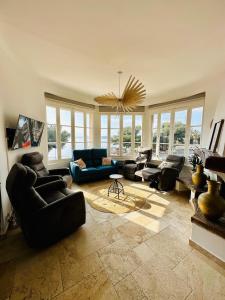 a living room with couches and a chandelier at Centre San Peire Les Issambres in Les Issambres