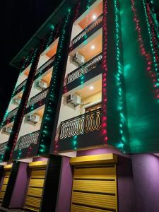 a building lit up with christmas lights at D'souza's Guest House in Tivim
