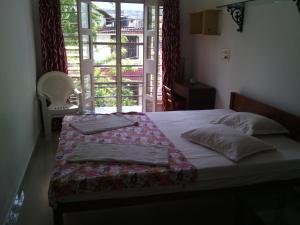 a bedroom with a bed and a window with a view at Nathans Holiday Home in Cochin +81 photos