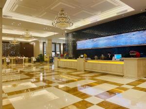 a lobby of a hotel with a large screen at Shenzhen Shuidu Holiday Hotel, North Railway Station in Shenzhen