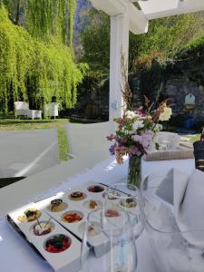 a table with several plates of food on it at Villa Maria Laura in Lierna