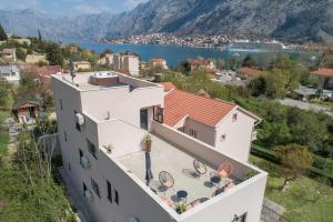 a white building with a view of a city and a body of water at Marea DeLuxe Apartments in Kotor