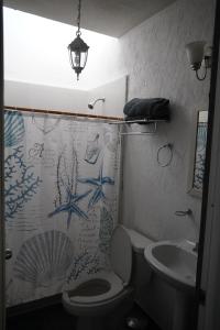 a bathroom with a toilet and a sink at Marineros Vallarta in Puerto Vallarta +16 photos