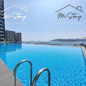 a large blue swimming pool on top of a building at MiStay 4-5PAX Luxury Suite Apartments in Kota Kinabalu