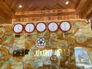 a group of clocks on a rock wall at Cherry Luxury Hotel in Da Lat