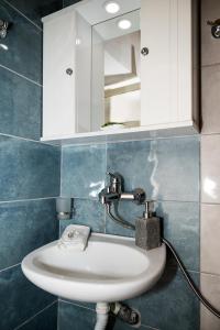a bathroom with a sink and a mirror at Ifigenia Cheerful and Cosy Entire Home with patio! in Anilio Pelion
