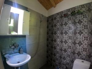 a bathroom with a sink and a toilet at Ifigenia Cheerful and Cosy Entire Home with patio! in Anilio Pelion
