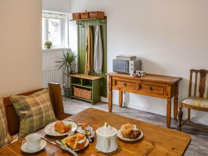a living room with a table with food on it at Allotment Cottage in Rothbury