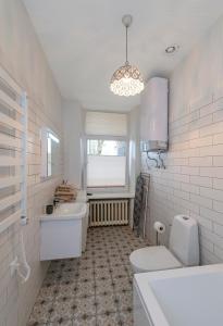 a bathroom with a tub and a sink and a toilet at Freedom Avenue Apartment by Polo apartments in Kaunas