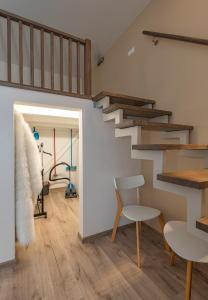 a living room with stairs and a table and chairs at Freedom Avenue Apartment by Polo apartments in Kaunas