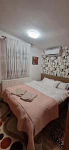 Un dormitorio con una cama grande con dos vasos. en View Cozia en Călimăneşti