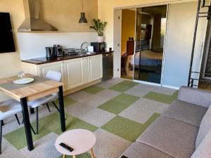 a kitchen and a living room with a couch and a table at Veeriku Villa in Tartu