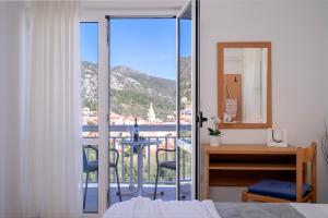 a bedroom with a view of a balcony at Guesthouse Novak in Hvar